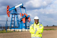 Oilfield worker in front of a pumpjack