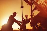 Field operators reviewing production data on site